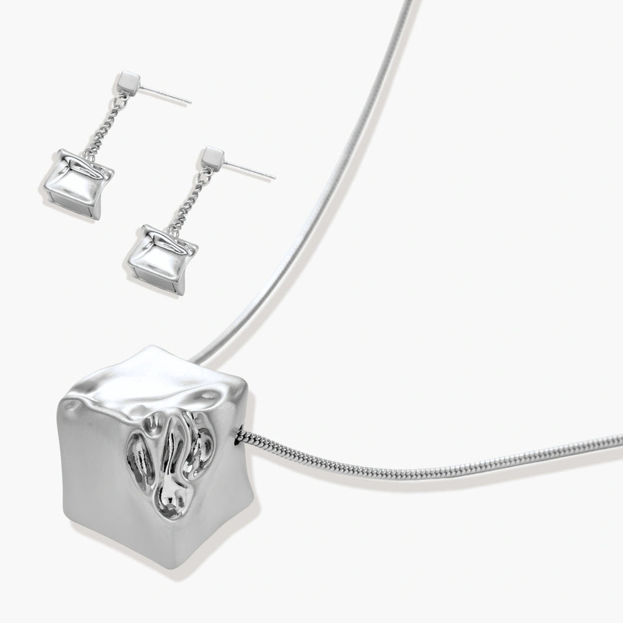 Geometric jewelry set with textured cube pendants on chains, featuring eco-zinc alloy in silver and gold finishes.
