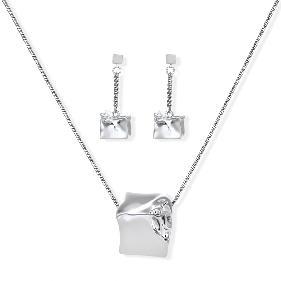 Geometric jewelry set with textured cube pendants on chains, featuring eco-zinc alloy in silver and gold finishes.