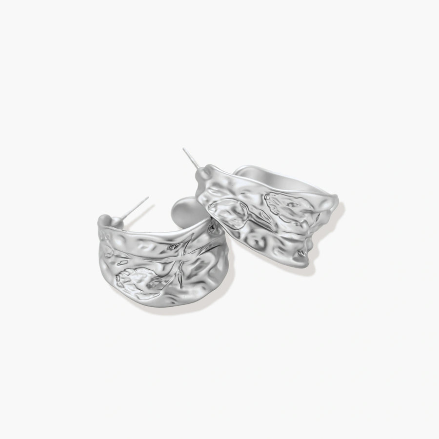 Textured silver jewelry set with floral engravings featuring adjustable cord necklace and matching hoop earrings