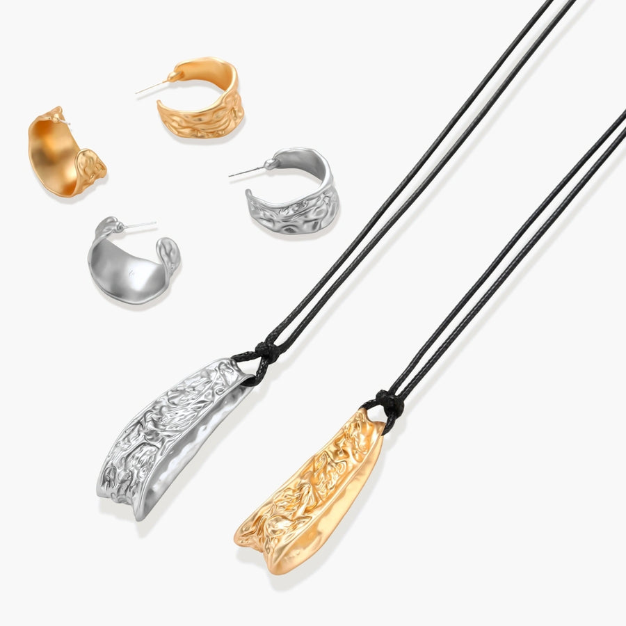 Textured silver jewelry set with floral engravings featuring adjustable cord necklace and matching hoop earrings
