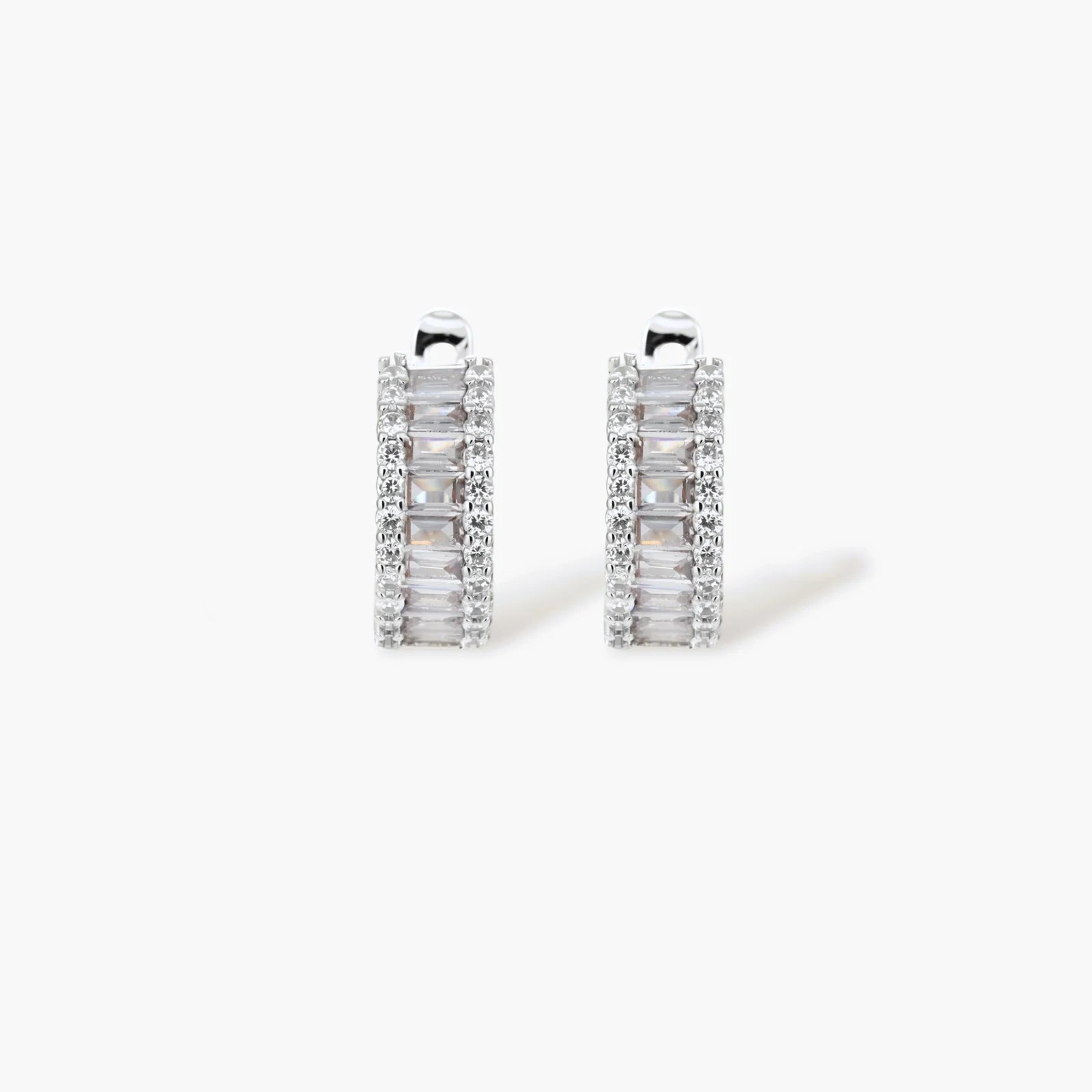 White gold plated necklace with vertical cubic zirconia pendant and matching hoop earrings on neutral background