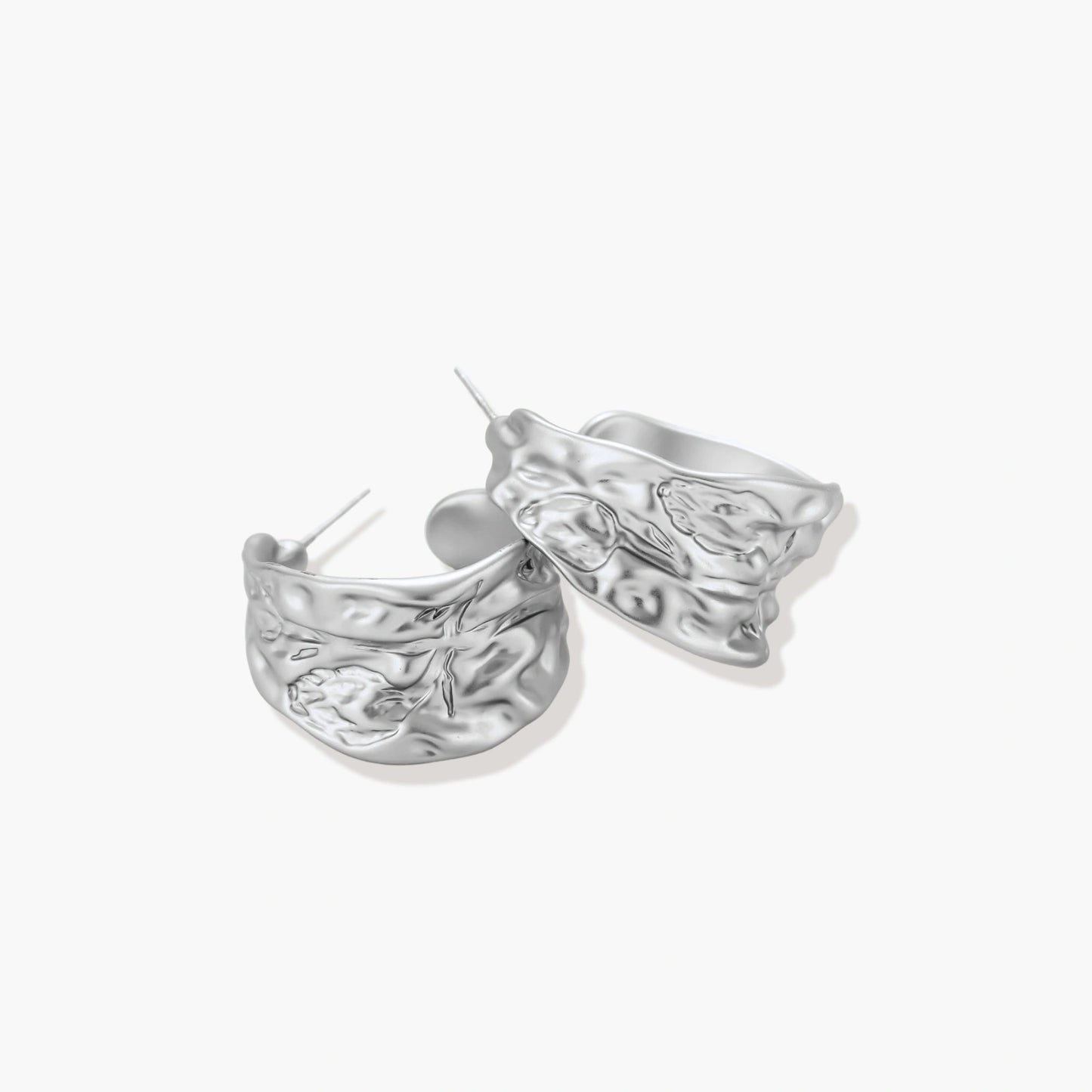 Textured silver jewelry set with floral engravings featuring adjustable cord necklace and matching hoop earrings