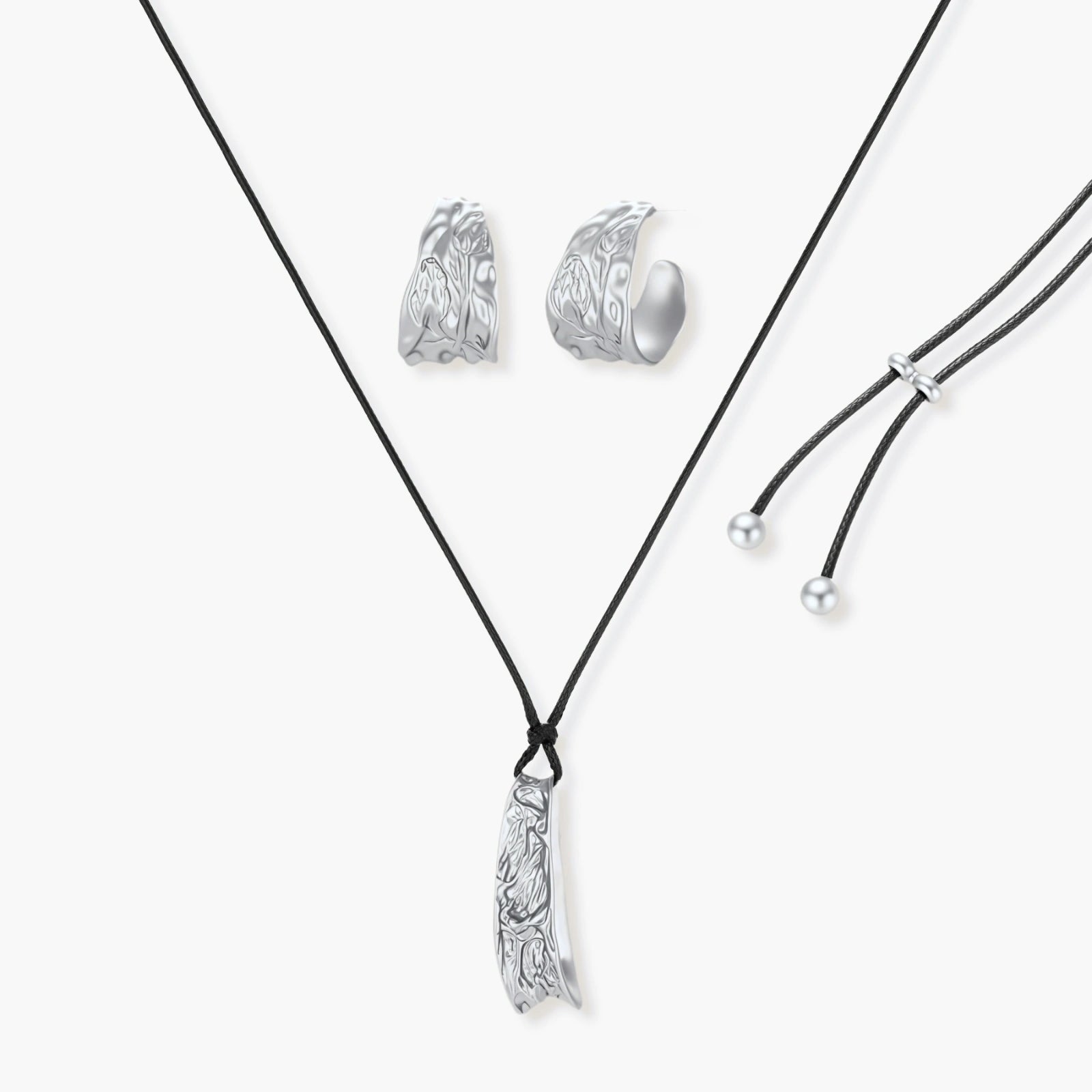 Textured silver jewelry set with floral engravings featuring adjustable cord necklace and matching hoop earrings