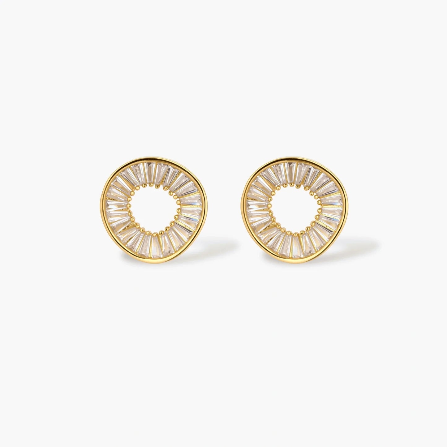 Gold-plated necklace and earring set with circular CZ crystal pendants featuring radial design on cream background